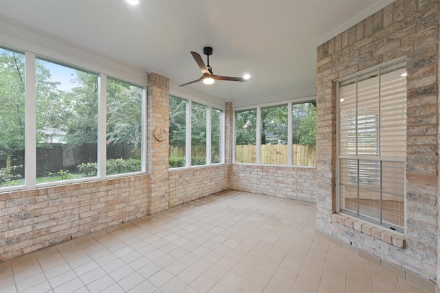 11 Forge Hill Pl, The Woodlands, TX 77381 - unfurnished sunroom featuring tile patterned floors, plenty of natural light, and brick wall