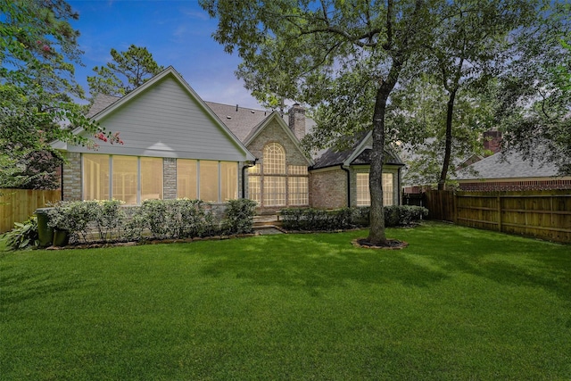 11 Forge Hill Pl, The Woodlands, TX 77381 - rear view of property featuring a fenced backyard, a chimney, and brick siding