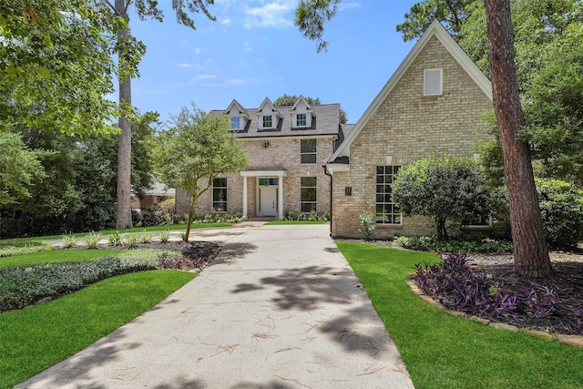11 Forge Hill Pl, The Woodlands, TX 77381 - view of front of house with brick siding and a front lawn