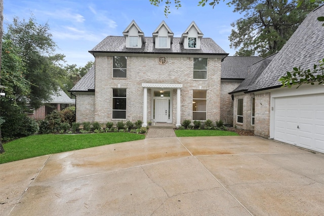 11 Forge Hill Pl, The Woodlands, TX 77381 - view of front of house featuring brick siding, concrete driveway, a front lawn, and roof with shingles