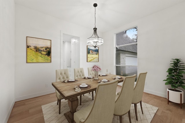 11 Forge Hill Pl, The Woodlands, TX 77381 - dining space with a chandelier and light wood-type flooring