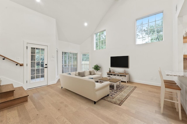 11 Forge Hill Pl, The Woodlands, TX 77381 - living room featuring high vaulted ceiling, stairway, light wood-type flooring, recessed lighting, and healthy amount of natural light