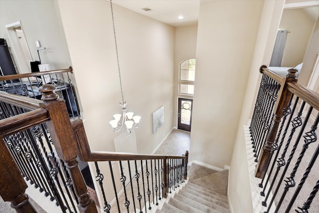 28842 Thornbird Ct, Katy, TX 77494 - stairs featuring a chandelier, a towering ceiling, recessed lighting, and carpet