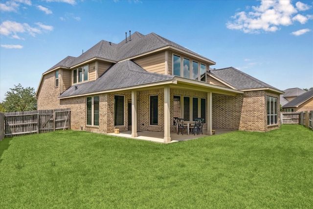 28842 Thornbird Ct, Katy, TX 77494 - back of house with brick siding, a fenced backyard, a shingled roof, and a patio area