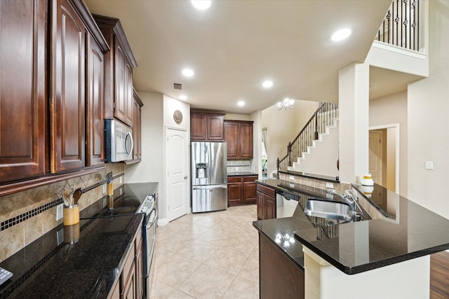28842 Thornbird Ct, Katy, TX 77494 - kitchen with appliances with stainless steel finishes, decorative backsplash, recessed lighting, a spacious island, and light tile patterned floors