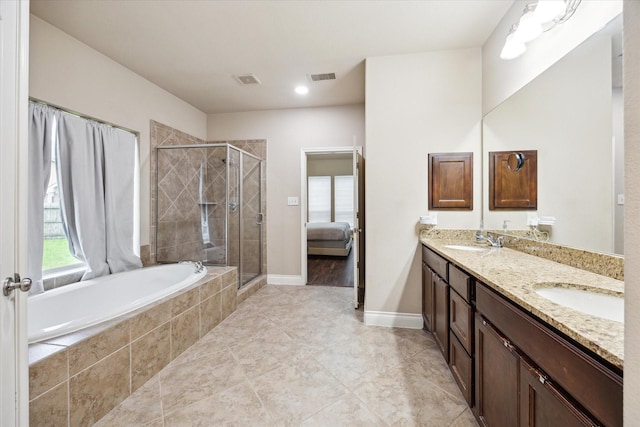 28842 Thornbird Ct, Katy, TX 77494 - ensuite bathroom featuring double vanity, a shower stall, a garden tub, and plenty of natural light