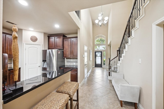 28842 Thornbird Ct, Katy, TX 77494 - kitchen with stainless steel fridge with ice dispenser, a chandelier, tasteful backsplash, recessed lighting, and a breakfast bar