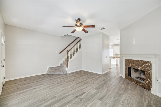 2930 Grants Lake Blvd Unit 2104, Sugar Land, TX 77479 - unfurnished living room with ceiling fan, light wood-type flooring, stairs, and a fireplace