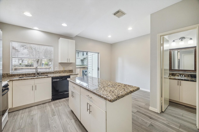 2930 Grants Lake Blvd Unit 2104, Sugar Land, TX 77479 - kitchen with dishwasher, range, light wood finished floors, a kitchen island, and light stone countertops