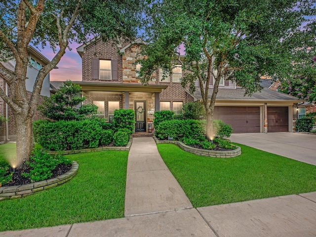 10515 Trinity Springs Dr, Cypress, TX 77433 - traditional-style home with driveway, a lawn, brick siding, and stone siding
