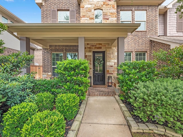 10515 Trinity Springs Dr, Cypress, TX 77433 - property entrance with a porch, stone siding, and brick siding