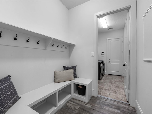 10515 Trinity Springs Dr, Cypress, TX 77433 - mudroom with washer and clothes dryer and wood finished floors