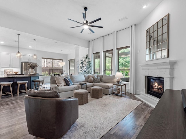 10515 Trinity Springs Dr, Cypress, TX 77433 - living room with a ceiling fan, recessed lighting, wood finished floors, and a glass covered fireplace