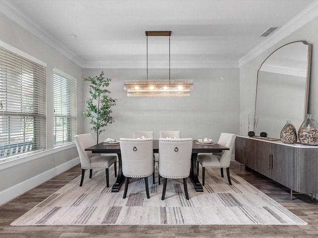 10515 Trinity Springs Dr, Cypress, TX 77433 - dining room featuring wood finished floors, ornamental molding, and a chandelier