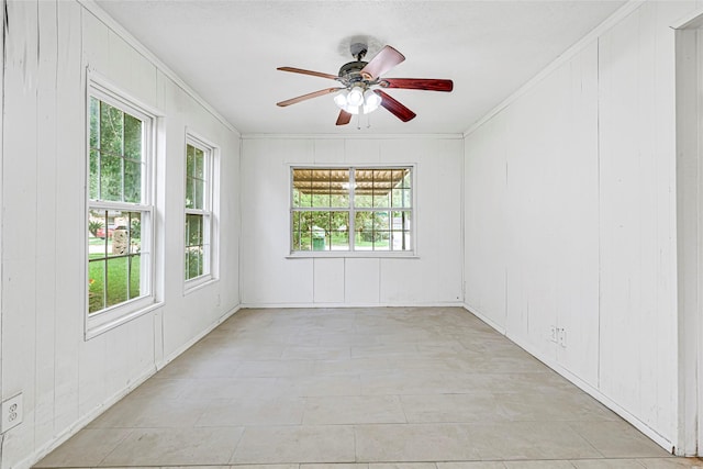 12434 Kathryn St, Houston, TX 77015 - spare room with crown molding, healthy amount of natural light, ceiling fan, and a decorative wall
