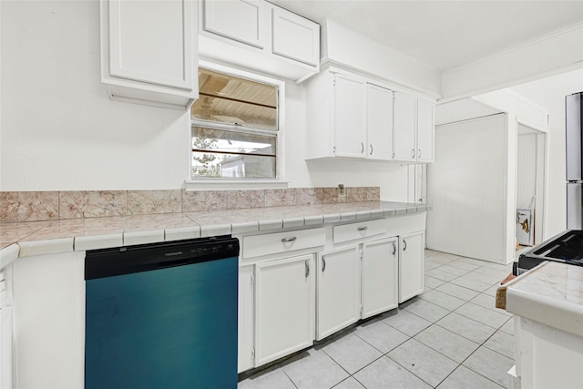 12434 Kathryn St, Houston, TX 77015 - kitchen featuring dishwashing machine, white cabinetry, light tile patterned floors, and stove