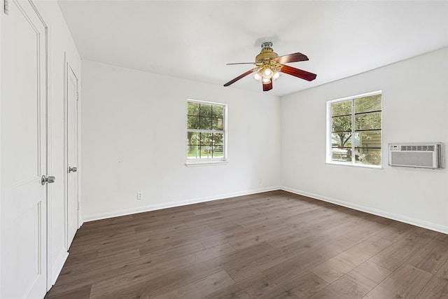 12434 Kathryn St, Houston, TX 77015 - spare room featuring a wall unit AC, dark wood-style floors, and a ceiling fan