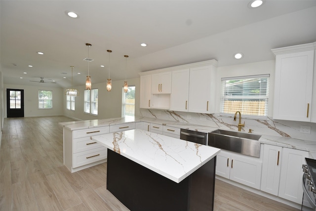 729 Caperton St, Houston, TX 77022 - kitchen with recessed lighting, a peninsula, stainless steel dishwasher, open floor plan, and a kitchen island