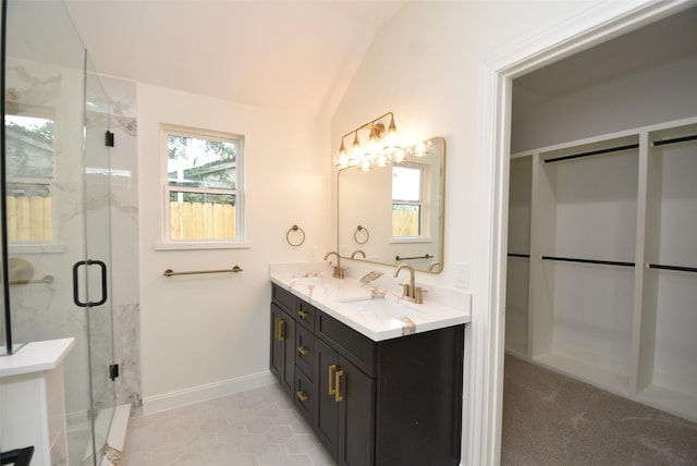 729 Caperton St, Houston, TX 77022 - bathroom featuring double vanity, plenty of natural light, lofted ceiling, a shower stall, and tile patterned flooring