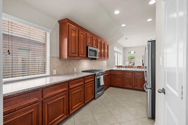 31870 Forest Park Trl, Conroe, TX 77385 - kitchen featuring appliances with stainless steel finishes, light stone counters, recessed lighting, decorative backsplash, and light tile patterned floors