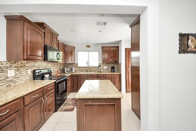 13411 Natasha Ln, Houston, TX 77015 - kitchen with black appliances, backsplash, light tile patterned floors, a kitchen island, and light stone countertops