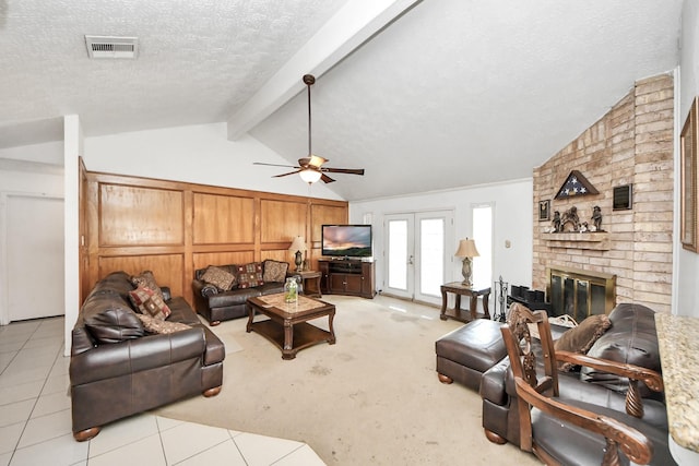 13411 Natasha Ln, Houston, TX 77015 - living room with a textured ceiling, ceiling fan, light carpet, a brick fireplace, and light tile patterned floors