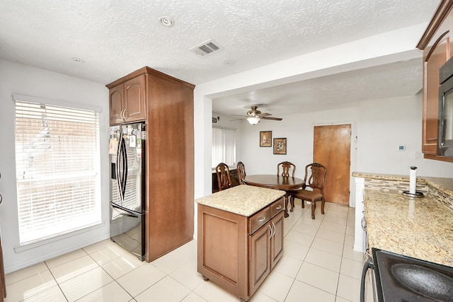 13411 Natasha Ln, Houston, TX 77015 - kitchen featuring smart refrigerator, ceiling fan, electric stove, light tile patterned floors, and a textured ceiling