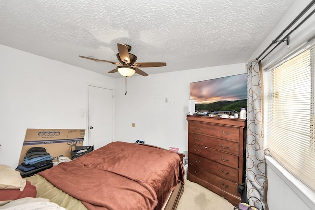 13411 Natasha Ln, Houston, TX 77015 - bedroom with a textured ceiling, a ceiling fan, and light carpet