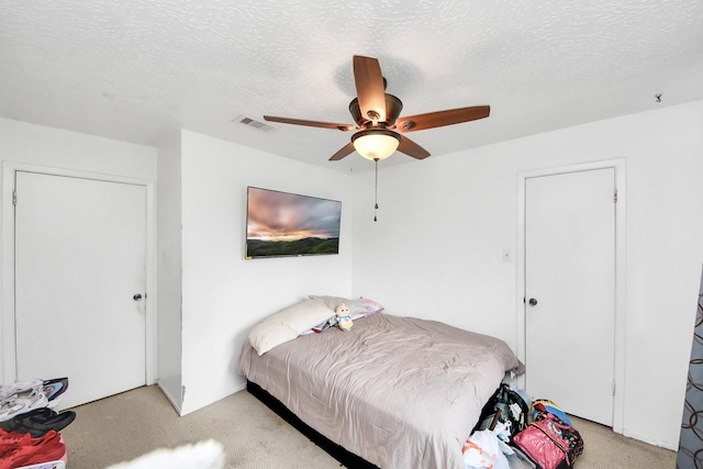 13411 Natasha Ln, Houston, TX 77015 - bedroom featuring a ceiling fan, a textured ceiling, and light carpet