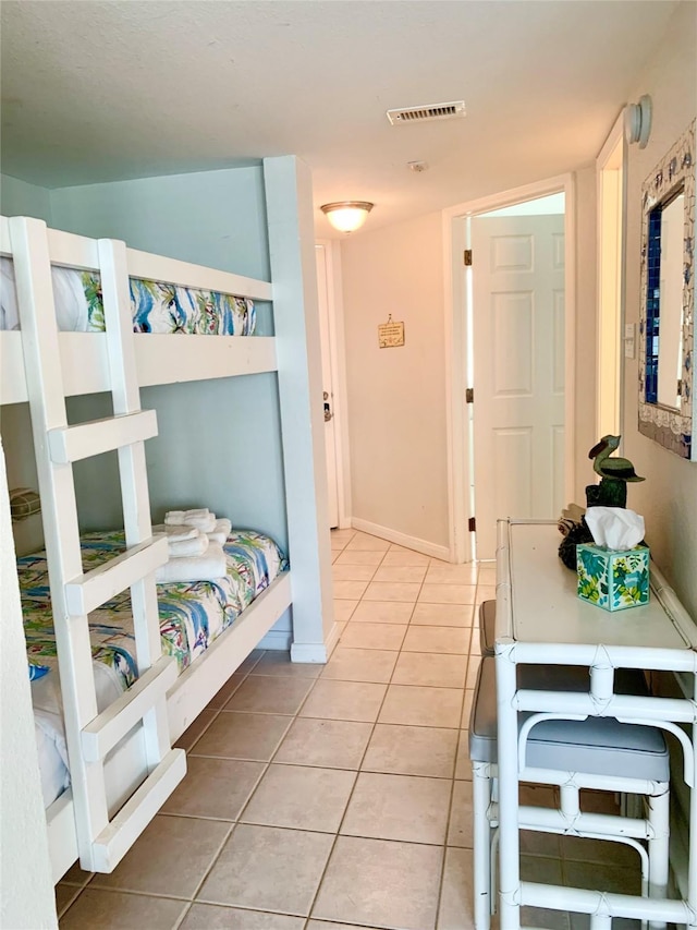 10811 San Luis Pass Rd Unit 1213, Galveston, TX 77554 - bedroom with light tile patterned flooring and baseboards