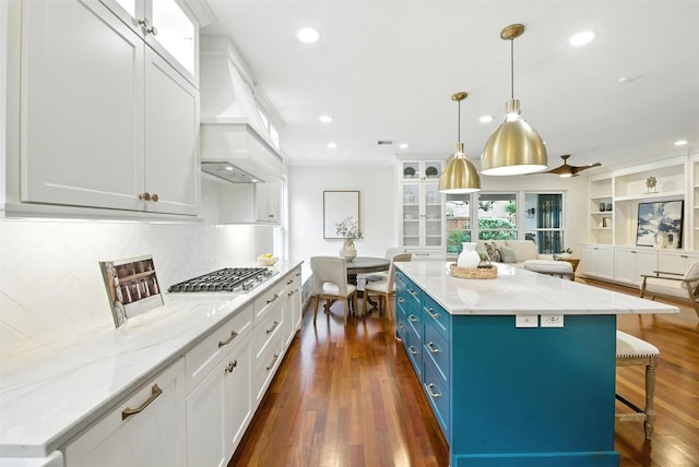 1211 Villmont Ln, Houston, TX 77077 - kitchen featuring blue cabinets, stainless steel gas cooktop, white cabinetry, open floor plan, and recessed lighting