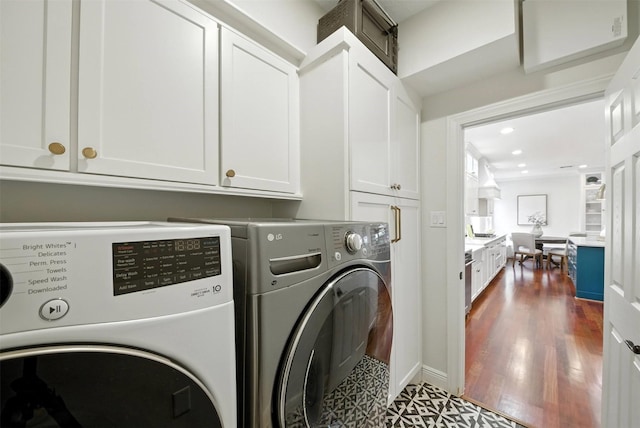 1211 Villmont Ln, Houston, TX 77077 - washroom featuring washing machine and clothes dryer, cabinet space, dark floors, and recessed lighting