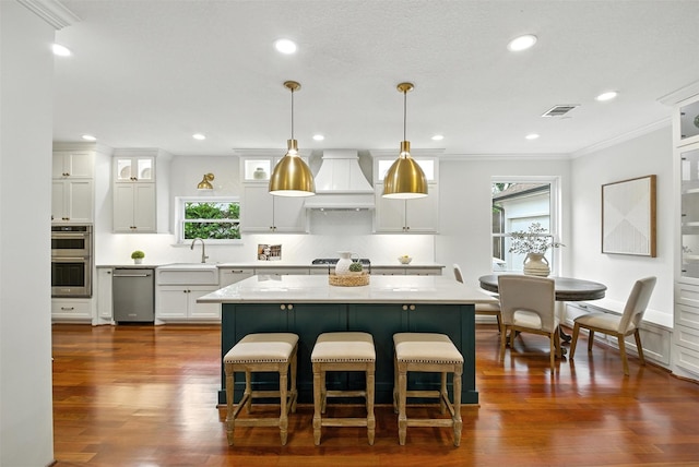 1211 Villmont Ln, Houston, TX 77077 - kitchen featuring custom exhaust hood, light countertops, a kitchen island, dark wood-style flooring, and white cabinetry