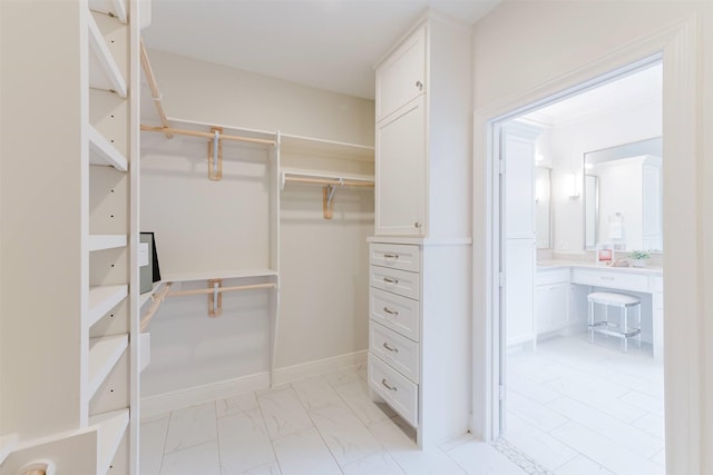 1211 Villmont Ln, Houston, TX 77077 - spacious closet featuring light marble finish flooring