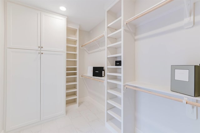 1211 Villmont Ln, Houston, TX 77077 - spacious closet featuring light marble finish floors