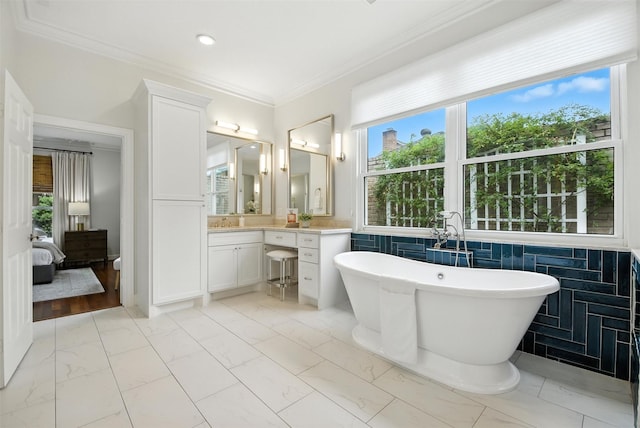 1211 Villmont Ln, Houston, TX 77077 - ensuite bathroom with vanity, a freestanding bath, marble finish flooring, plenty of natural light, and ornamental molding