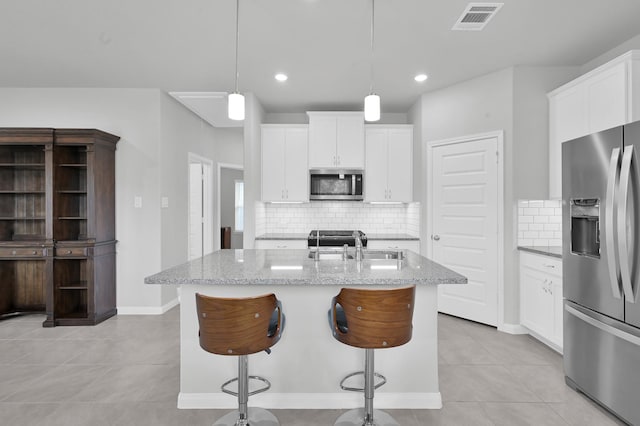18529 Meadow Point Ln, Montgomery, TX 77316 - kitchen with stainless steel appliances, light stone counters, tasteful backsplash, light tile patterned floors, and recessed lighting