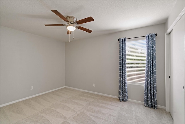 12106 Hawthorne Hill Cir, Humble, TX 77346 - empty room featuring light colored carpet, ceiling fan, and a textured ceiling