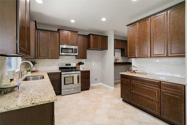 12106 Hawthorne Hill Cir, Humble, TX 77346 - kitchen with stainless steel appliances, light stone counters, tasteful backsplash, recessed lighting, and dark brown cabinetry