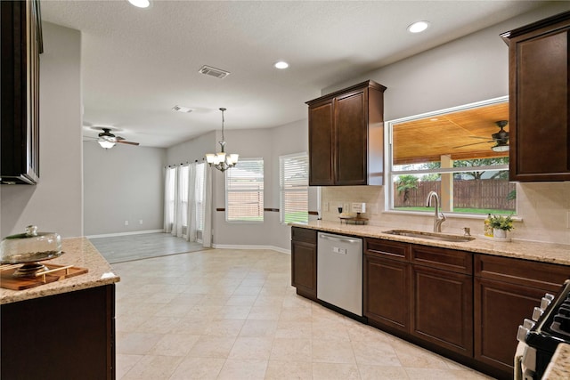 12106 Hawthorne Hill Cir, Humble, TX 77346 - kitchen with stainless steel appliances, ceiling fan, dark brown cabinetry, decorative backsplash, and light stone counters