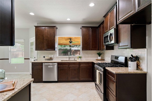 12106 Hawthorne Hill Cir, Humble, TX 77346 - kitchen with appliances with stainless steel finishes, dark brown cabinetry, plenty of natural light, backsplash, and recessed lighting