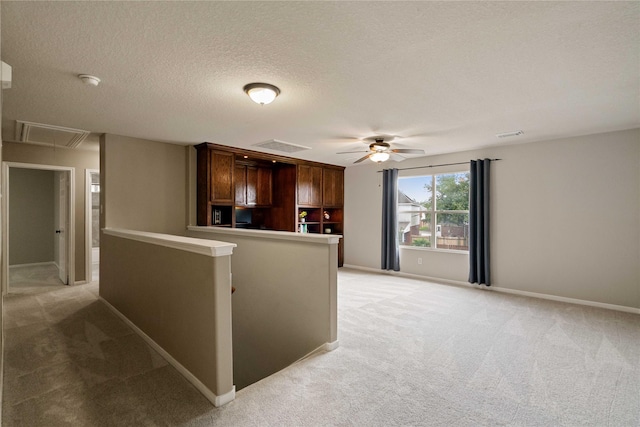12106 Hawthorne Hill Cir, Humble, TX 77346 - kitchen featuring light colored carpet, ceiling fan, and a textured ceiling