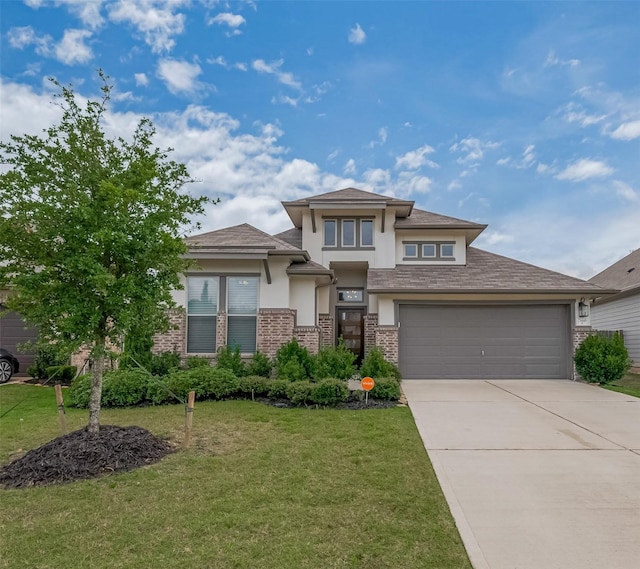 25446 Fossa Dr, Tomball, TX 77375 - prairie-style home featuring stucco siding, brick siding, driveway, and a front lawn