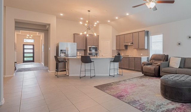 25446 Fossa Dr, Tomball, TX 77375 - living room featuring light tile patterned flooring, ceiling fan, a chandelier, recessed lighting, and lofted ceiling