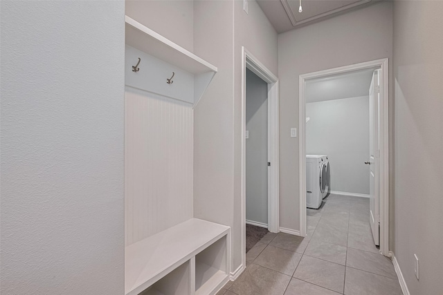 25446 Fossa Dr, Tomball, TX 77375 - mudroom featuring washing machine and clothes dryer, attic access, and light tile patterned flooring