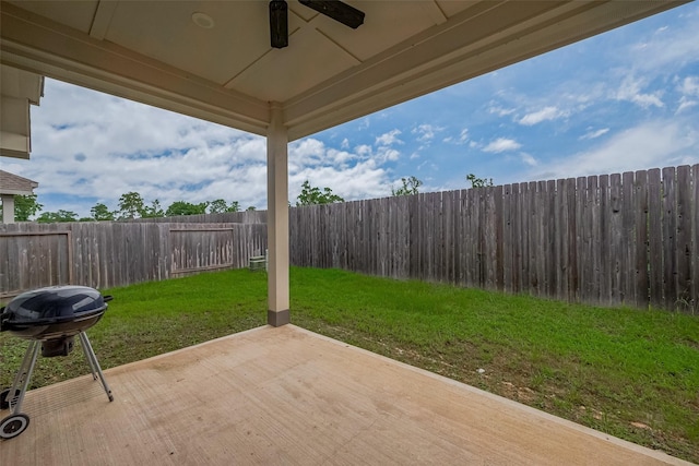 25446 Fossa Dr, Tomball, TX 77375 - fenced backyard with ceiling fan, a patio area, and a grill