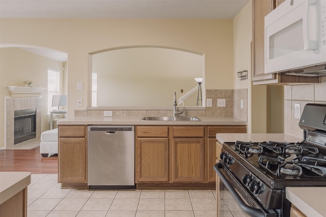 18107 Mayfield Meadow Ln, Richmond, TX 77407 - kitchen with stainless steel dishwasher, gas range oven, white microwave, and light countertops