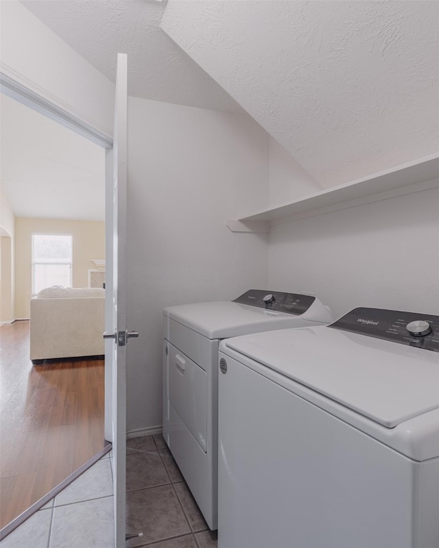 18107 Mayfield Meadow Ln, Richmond, TX 77407 - laundry room featuring washer and dryer, tile patterned floors, and a textured ceiling