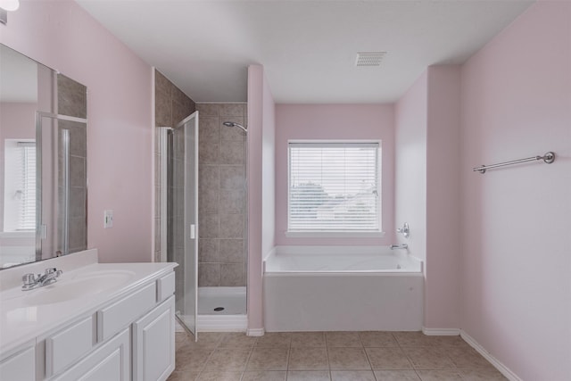 18107 Mayfield Meadow Ln, Richmond, TX 77407 - bathroom with vanity, a stall shower, a garden tub, and tile patterned floors