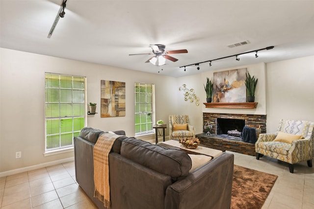 2151 Middle Creek Dr, Houston, TX 77339 - living area featuring track lighting, light tile patterned floors, ceiling fan, and a fireplace